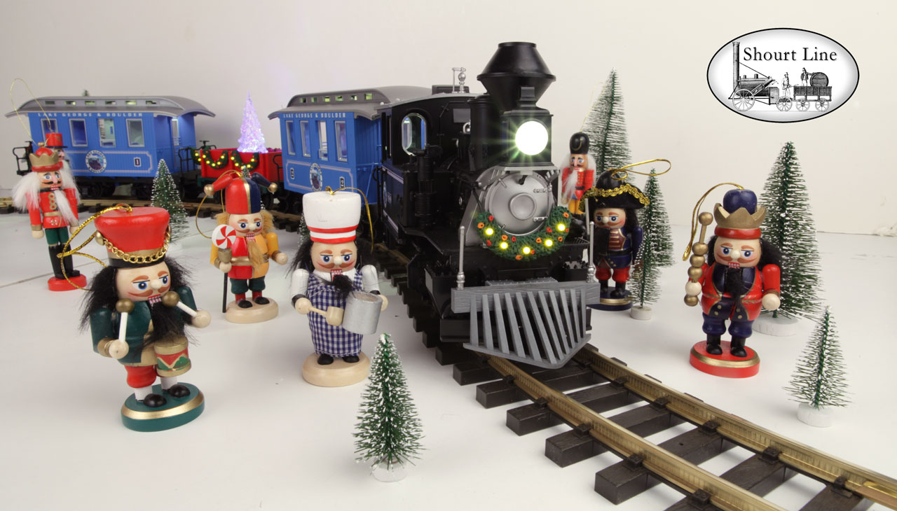 G Scale Shourt Line LGB 72327 HLW 15105 G Scale Ultimate Hybrid 71 LED Passenger Christmas Train Starter Set front and right side low angle