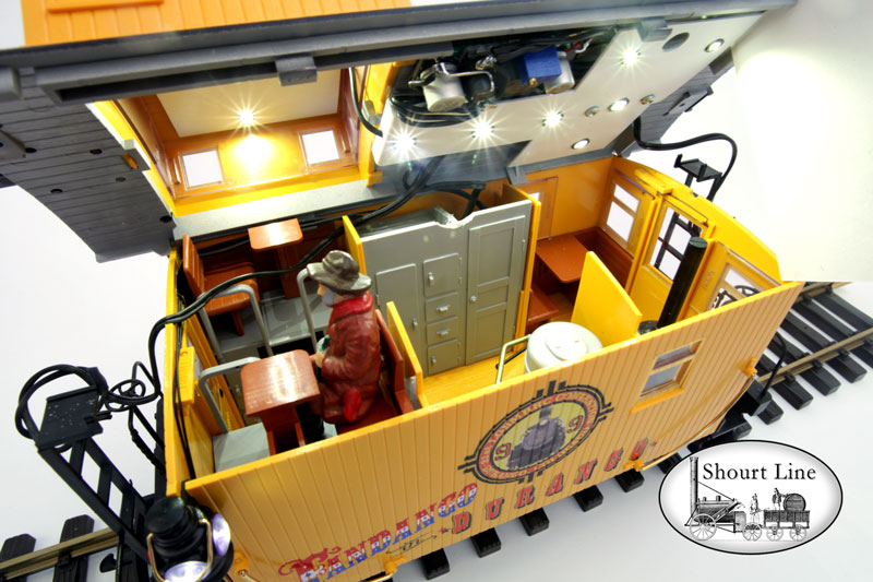 LGB 47656 Fandango in Durango 8-wheel Bobber Caboose + SL 8134230 13 LED High Efficiency dual ceiling fixtures and 2 coach LEDs + SL 8453303 Precision Train Throttle & LED controller + SL 6011604 Extreme low drag power pick-up for LGB two axle trucks + 2 each PIKO 36161 Metal Wheel sets + 10,000uF buffer anti-flicker capacitor Interior view roof lifted up